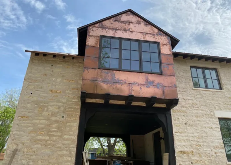 Copper metal panel facade on a stone building for Roof Repair in Delano