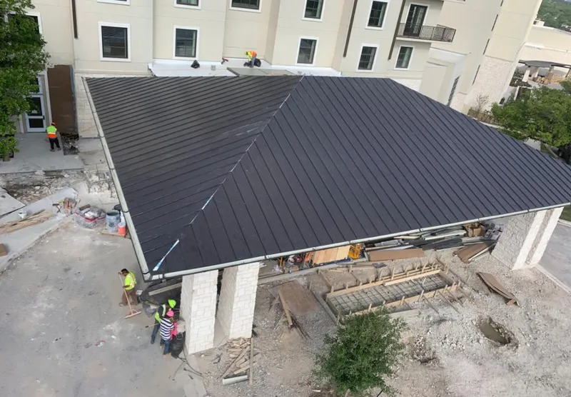 Metal roofing installation team working on a commercial building in Delano
