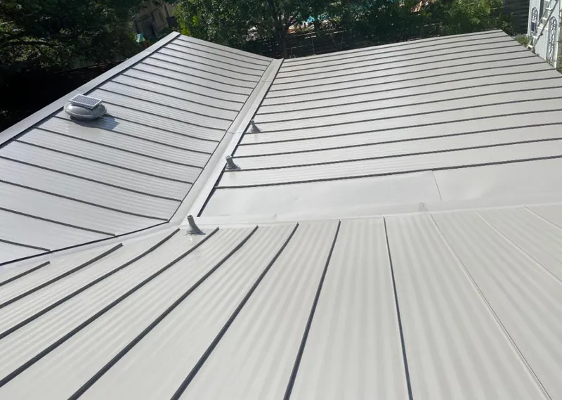 Solar attic fan installed on a metal roof for Roof Ventilation in Delano